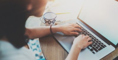 person searching on macbook