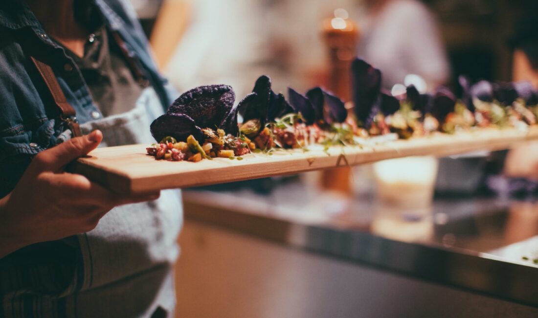 Person carrying a plank of food