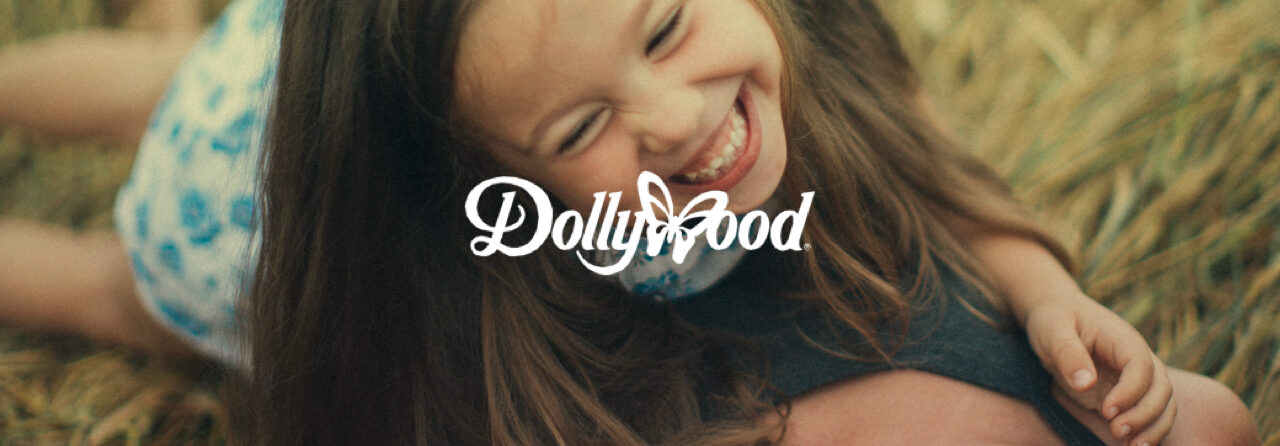 http://Little%20girl%20laughing%20with%20the%20DollyWood%20logo%20superimposed